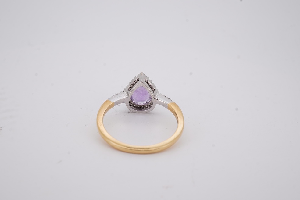 A modern 18ct gold and single stone pear cut amethyst set ring, with diamond chip set border and shoulders, size O, gross weight 3.4 grams. Condition - fair to good